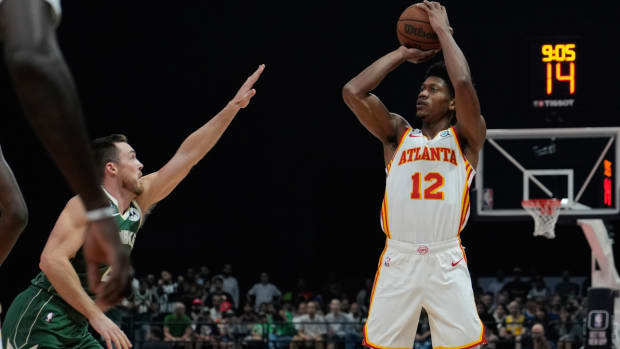 De’Andre Hunter of Atlanta Hawks shoots by Pat Connaughton of Milwaukee Bucks during a preseason NBA basketball game in Abu Dhabi, United Arab Emirates, Saturday, Oct. 8, 2022. (AP Photo/Kamran Jebreili)